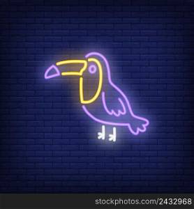 Toucan neon sign. Tropical bird on dark brick wall background. Night bright advertisement. Vector illustration in neon style for pet shop or zoo