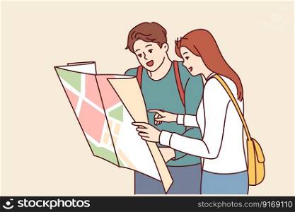 Tourist couple of man and woman looking at map choosing new city for travel or searching for hotel location. Guy and girl travel to new places enjoying vacation together on summer weekend . Tourist couple of man and woman looking at map choosing new city for summer travel