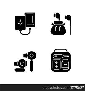 Traveller luggage black glyph icons set on white space. Compact powerbank and headphones. First aid kit. Mini size objects for tourist comfort. Silhouette symbols. Vector isolated illustration. Traveller luggage black glyph icons set on white space