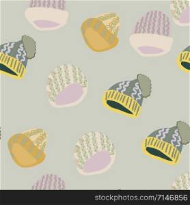 Trendy winter headwear knitted beanies seamless pattern on light green background. Web, wrapping paper, textile, wallpaper design, background fill.. Trendy winter headwear knitted beanies seamless pattern on light green background