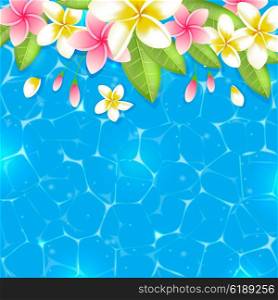 Tropical summer background with flowers and leaves in blue water. Pink and yellow tropical flowers on a blue background.