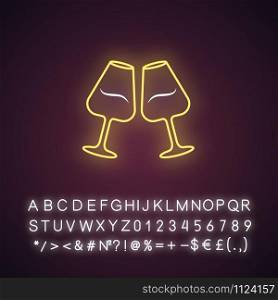 Two clinking wine glasses yellow neon light icon. Glassfuls of alcohol beverage. Wine service. Glassware. Cheers. Glowing sign with alphabet, numbers and symbols. Vector isolated illustration