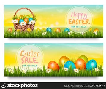 Two Easter Sale banners. Colorful eggs in green grass. Vector.