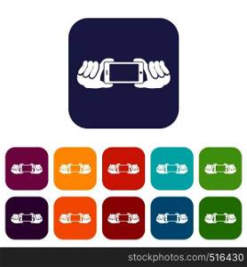Two hands holding mobile phone icons set vector illustration in flat style in colors red, blue, green, and other. Two hands holding mobile phone icons set