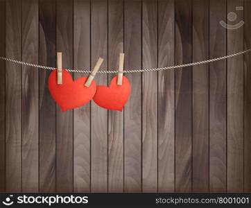 Two hearts hanging on a rope in front of wooden background. Valentine&rsquo;s day vector.