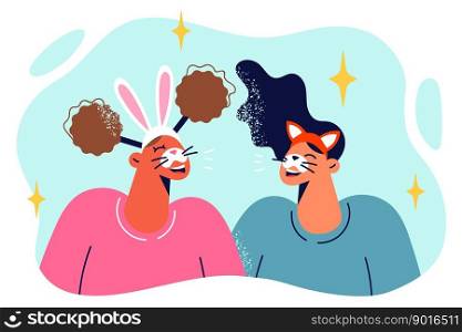 Two teenage girls wearing animal masks for masquerade ball or Halloween party. Happy teenagers with bunny and fox masks for going to school costume party laughing when see each other . Two teenage girls wearing animal masks for masquerade ball or Halloween or birthday party