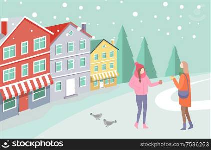 Two women in warm clothes standing outdoor on snowing street near colorful houses and trees. Girls speaking and holding cups near gulls on road vector. Women on Snowing Street near Colorful House Vector