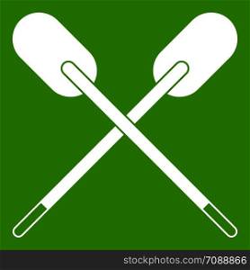 Two wooden crossed oars icon white isolated on green background. Vector illustration. Two wooden crossed oars icon green