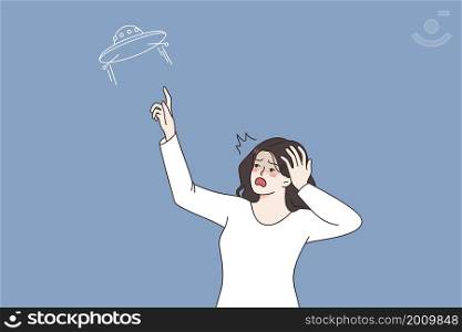 UFO and feeling shocked concept. Young amazed woman standing looking at sky and pointing at ufo ship flying on space feeling surprised and shock vector illustration . UFO and feeling shocked concept
