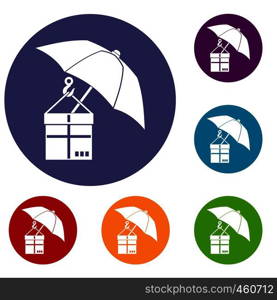 Umbrella and a cardboard box icons set in flat circle reb, blue and green color for web. Umbrella and a cardboard box icons set