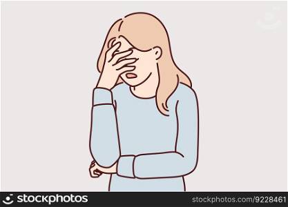 Upset girl covers face with hand due to stress and lack of strength to solve problems. Woman doing facepalm gesture feeling stressed and depressed or frustrated after another failure . Upset girl covers face with hand due to stress and lack of strength to solve problem