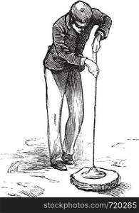 Vacuum cleaner or Vacuum, vintage engraving. Old engraved illustration of man using a vacuum cleaner.