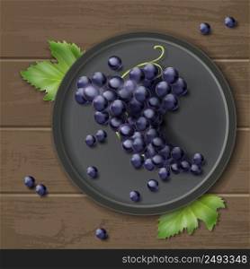 Vector bunch of grapes on plate with leaves, isolated on wooden background, top view. Bunch of grapes