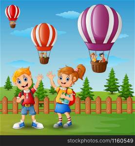 Vector illustration of School of a boy and a girl waving hand outside the fence with a hot air balloon