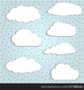 Vector illustration of white clouds in polka background