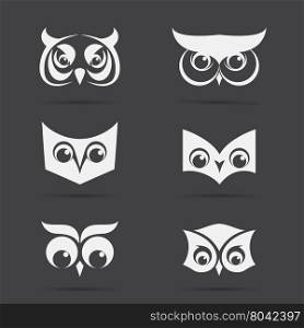 Vector image of an owl face design on black background. Vector owl face for your design.