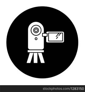 Video camera glyph icon. Digital recording gadget. Electronic motion picture. Filming, shooting. Portable camcorder. Handheld mobile device. Vector white silhouette illustration in black circle