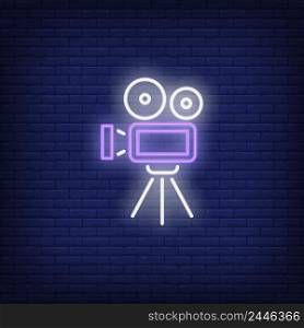 Video camera neon sign. Luminous signboard with retro film production equipment. Night bright advertisement. Vector illustration in neon style for vintage movie, filmmaking, videographer, creativity