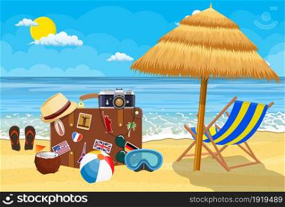 Vintage old travel suitcase on beach. Leather retro bag with stickers. Hat, photo camera, eyeglasses, coconut. wooden chaise lounge, umbrella. Vacation travel. Vector illustration flat style. Vintage old travel suitcase on beach.