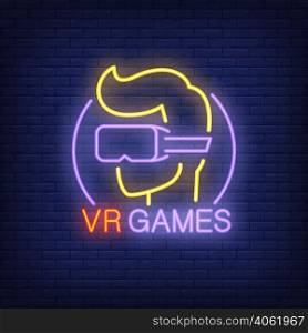VR Games lettering and player in glasses neon sign on brick background. Augmented reality, videogame, club. Game concept. For topics like entertainment, leisure, technology