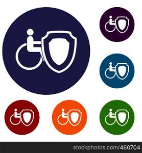 Wheelchair and safety shield icons set in flat circle reb, blue and green color for web. Wheelchair and safety shield icons set