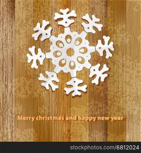 White paper christmas snowflake on a wood background. + EPS8 vector file