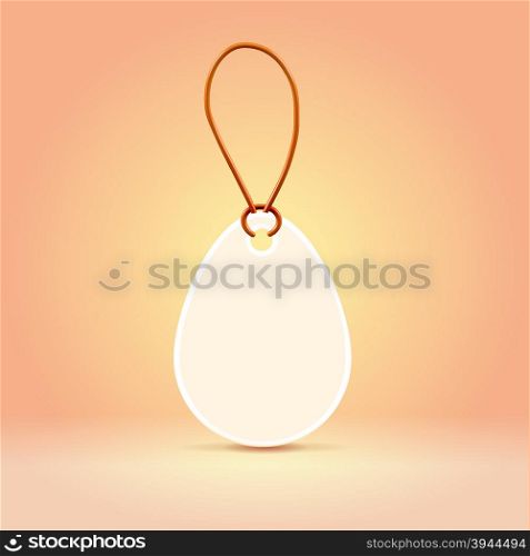 White plastic egg shaped label tag in an peach environment