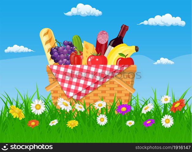WIcker picnic basket full of products. Wine, sausage, bacon and cheese, apple, tomato, cucumber. Grass, flowers, sky with clouds. Vector illustration in flat style. WIcker picnic basket full of products.