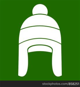 Winter hat icon white isolated on green background. Vector illustration. Winter hat icon green