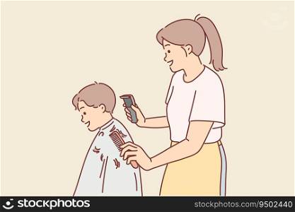 Woman children hairdresser cuts little boy hair and holds trimmer and comb in hands. Girl hairdresser serves client of elementary school student or makes fashionable hairstyle for child.. Woman children hairdresser cuts little boy hair and holds trimmer and comb in hands