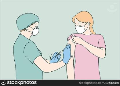 Woman doctor in protective medical mask and uniform holding syringe before making injection to young female patient in medical clinic. Vaccination, Covid-19 coronavirus vaccine concept . Vaccination, Covid-19 coronavirus vaccine concept 