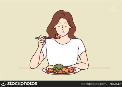 Woman eats appetizing fresh vegetable salad and closes eyes, enjoying delicious and healthy diet. Girl has lunch or dinner with vegetables, according to advice of nutritionist, recommended new diet. Woman eats appetizing fresh vegetable salad and closes eyes, enjoying delicious and healthy diet