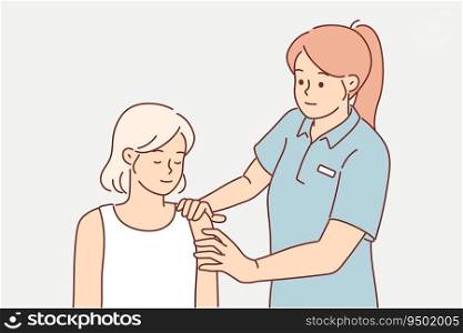 Woman fitness instructor massages shoulder of athlete helping to warm up before training. Massage from fitness trainer for client who suffered dislocated arm due to negligence in gym. Woman fitness instructor massages shoulder of athlete helping to warm up before training