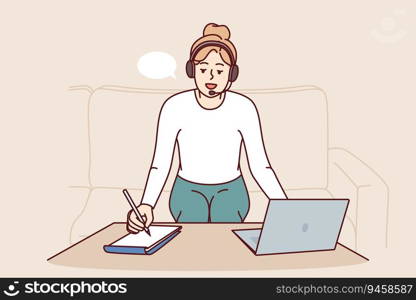 Woman freelancer with headset working from home sitting on sofa near table with laptop and making notes on paper. Freelancer girl makes remote career as translator or support specialist. Woman freelancer with headset working from home sitting on sofa near table with laptop