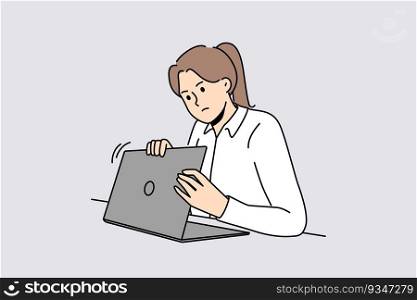 Woman is worried about privacy of data on internet and hides laptop screen while entering password. Taking care of security using internet and maintaining confidentiality to avoid information leakage. Woman is worried about privacy of data on internet and hides laptop screen while entering password