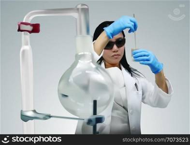 Woman Scientist Using Pipette in Laboratory