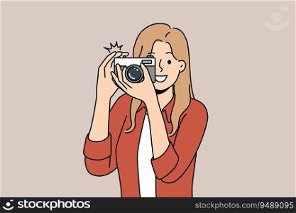 Woman with camera with smile takes photo for publication in newspaper or on pages of personal internet blog. Young happy girl uses camera to capture picturesque locations while traveling. Woman with camera with smile takes photo for publication in newspaper or personal internet blog