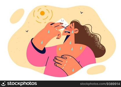 Woman with heatstroke wipes sweat from face, strolling on sunny street for concept of summer sickness in people. Unhealthy girl got heatstroke due to sharp warming associated with climate change. Woman with heatstroke wipes sweat from face due to sharp warming associated with climate change