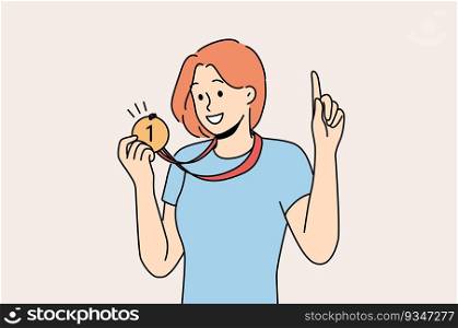 Woman with medal for first place won sports competition and is proud of trophy pointing finger up. Girl ch&ion boasts of award for winning olympiad or participants in competition among colleagues. Woman with medal for first place won sports competition and is proud of trophy pointing finger up