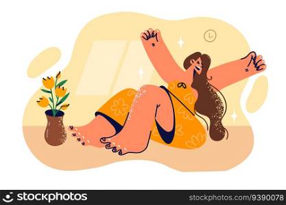 Woman yawns sitting on floor in apartment, stretching arms to sides after waking up early and rejoicing at weekend with opportunity to relax. Girl yawns or does morning wellness exercises. Woman yawns sitting on floor in apartment, stretching arms to sides after waking up early