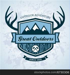 Wood themed outdoors emblem with mountains and antlers
