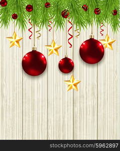 Wooden Christmas background with green fir branches, stars and red baubles