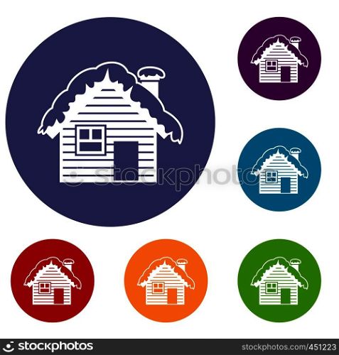 Wooden house covered with snow icons set in flat circle reb, blue and green color for web. Wooden house covered with snow icons set