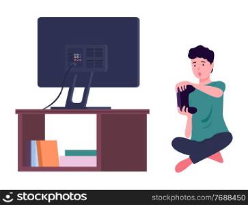 Worried boy with joystick in hands playing video game at tv screen, relaxing playing games at home sitting at floor. Indoors activity, hobby, recreation. Leisure time at home, isolated character. Worried boy with joystick in hands playing video game at tv screen, relaxing playing games at home