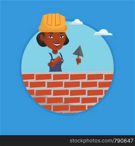 Young african-american bricklayer in uniform and hard hat. Smiling bicklayer working with spatula and brick on construction site. Vector flat design illustration in the circle isolated on background.. Bricklayer working with spatula and brick.