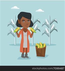 Young african-american farmer standing near basket with corn and holding corn cobs in hands on the background of corn field. Happy farmer collecting corn. Vector cartoon illustration. Square layout.. Young african farmer collecting corn harvest.