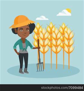 Young african-american farmer standing with a pitchfork on the background of a wheat field. Smiling farmer working with a pitchfork in a wheat field. Vector cartoon illustration. Square layout.. Young farmer standing in a field with pitchfork.