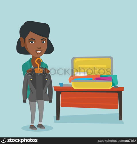 Young african-american woman packing clothes in an opened suitcase. Smiling woman putting a jacket into a suitcase. Cheerful woman preparing for vacation. Vector cartoon illustration. Square layout.. African woman packing clothes in a suitcase.