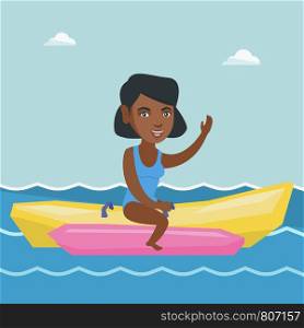 Young african-american woman riding a banana boat and waving hand. Cheerful woman having fun on a banana boat in the sea. Woman enjoying summer vacation. Vector cartoon illustration. Square layout.. Young african-american woman riding a banana boat.