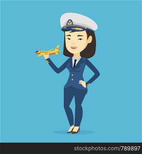 Young asian airline pilot holding model of airplane in hand. Cheerful airplane pilot in uniform. Smiling airplane pilot standing with model of airplane. Vector flat design illustration. Square layout.. Cheerful airline pilot with model airplane.